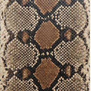 May include: Close-up of a snakeskin pattern. The design features a repeating scale pattern in shades of brown, tan, and black. The texture appears rough and detailed, with a naturalistic aesthetic.