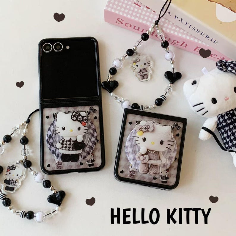 May include: Black phone case with a Hello Kitty design, featuring a black and white checkered pattern. The image includes a matching phone charm and a small plush toy, all with the Hello Kitty theme. The words "HELLO KITTY" are at the bottom.