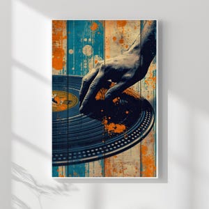 May include: A framed art print featuring a close-up of a DJ's hand on a vinyl record. The artwork has a vintage aesthetic with a blue, orange, and beige color palette. The background is a wooden plank design with paint splatters.