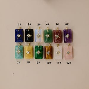 May include: Twelve rectangular pendants arranged in two rows, numbered 1# through 12#. Each pendant features a different colored stone with a gold-tone star-shaped charm centered on the front, accented by a small clear crystal at its core.