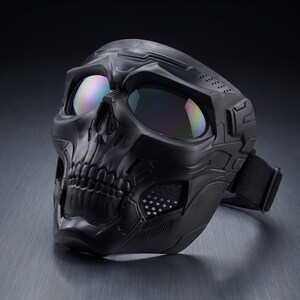 May include: A black skull mask with iridescent lenses. The mask features a detailed skull design with visible teeth and eye sockets. It has an adjustable strap and ventilation holes, suitable for costume or tactical use.