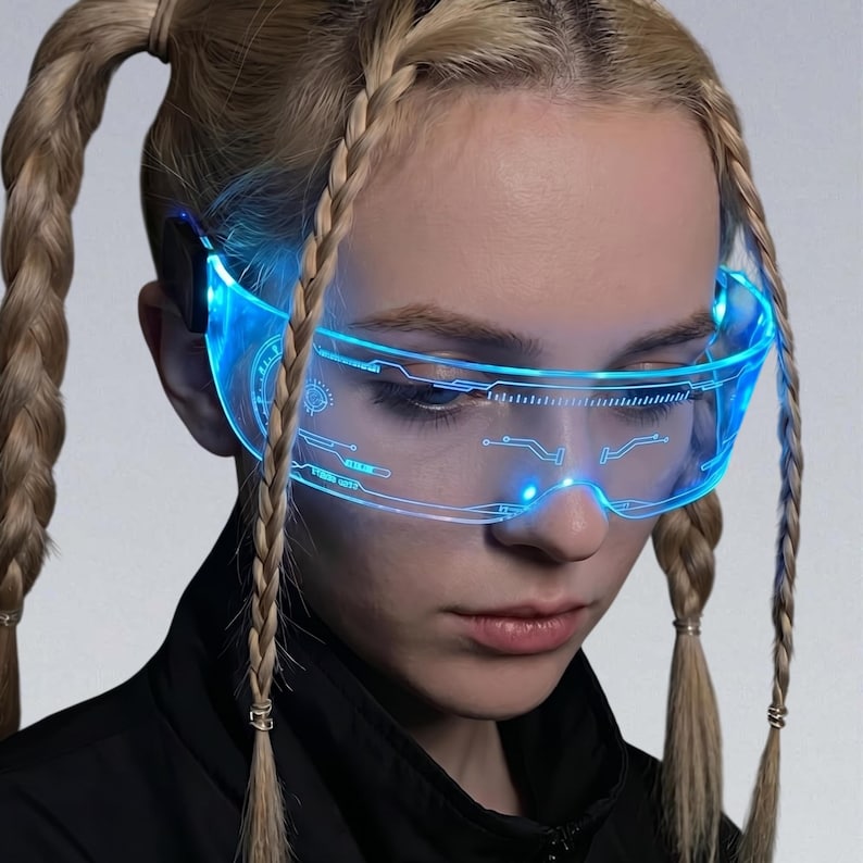 May include: Futuristic blue-light glasses with a sleek, transparent design. The glasses feature illuminated circuitry patterns and a glowing blue light, creating a high-tech aesthetic. The overall design suggests a cyberpunk or sci-fi theme.