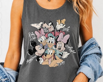 May include: Dark gray tank top featuring a graphic of Disney characters including Mickey Mouse, Minnie Mouse, Donald Duck, Daisy Duck, Goofy, and Pluto. The tank top is made of a soft material and has the words "Mickey Mouse", "Daisy Duck", "Minnie Mouse", and "Pluto" printed on it.