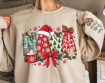 May include: A sand-colored crewneck sweatshirt featuring the word NANA in large letters with Christmas-themed patterns, a Santa hat, a red bow, and a mug. The sleeve displays the text Julie Kelly Olivia with a heart-shaped patterned icon.