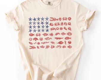 Camiseta Comfort Colors con la bandera de EE. UU. y diseño de conchas marinas, camiseta del 250 aniversario del 4 de julio, camiseta patriótica costera, bandera estadounidense náutica playera, regalo de EE. UU.