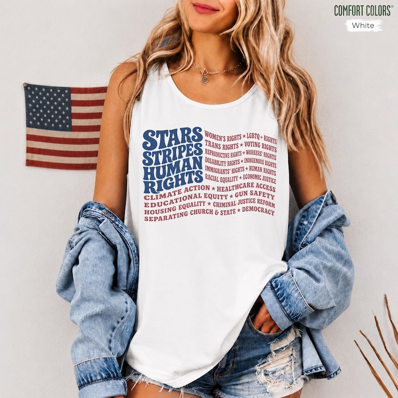 May include: A white sleeveless tank top featuring blue and red text that reads Stars Stripes Human Rights, followed by a list of social causes including Women's Rights, LGBTQ Rights, Voting Rights, Climate Action, and Healthcare Access.