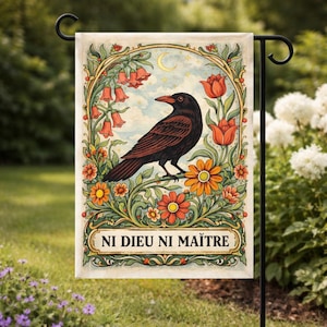 May include: A decorative garden flag featuring a detailed illustration of a crow perched on a floral branch. The crow is black and brown, surrounded by orange and yellow flowers, with the text "NI DIEU NI MAÎTRE" at the bottom.