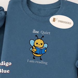 May include: A set of three ceramic mugs with a speckled, matte finish. The mugs are in shades of cream, light gray, and dark gray. Each mug has a simple, minimalist design and a rounded handle.