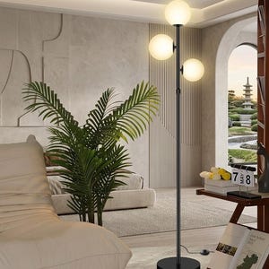 May include: A black floor lamp with three spherical, frosted glass shades. The lamp has a slender, vertical pole and a round base. The shades emit a warm, soft glow, illuminating the room. The lamp is a modern home decor item.