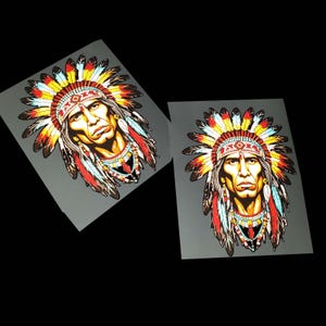May include: Two images of a Native American chief with a detailed headdress and necklace. The portraits feature a serious expression and are rendered in vibrant colors, including red, yellow, and blue. The background is a dark gray.