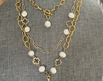 Gold chain link necklace with freshwater pearls and gold cross pendant. The 18k gold plate chain and cross is over brass.