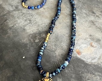 Beaded necklace or bracelet. Made with gemstones and gold fill beads and charm. Blue Lapis and Jasper.