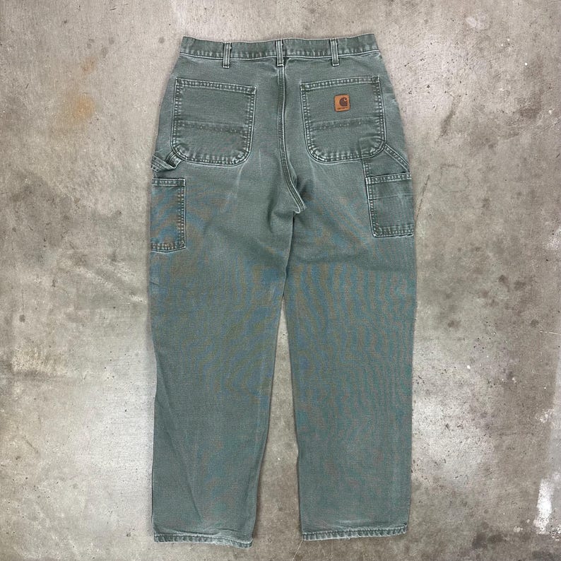 May include: A set of three ceramic mugs with a speckled, matte finish. The mugs are in shades of cream, light gray, and dark gray. Each mug has a simple, modern design and a rounded handle.