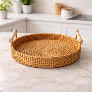 May include: A round, woven rattan tray with two wooden handles. The tray is light brown and has a textured surface. The handles are made of light-colored wood. This decorative tray is suitable for serving food or displaying items.