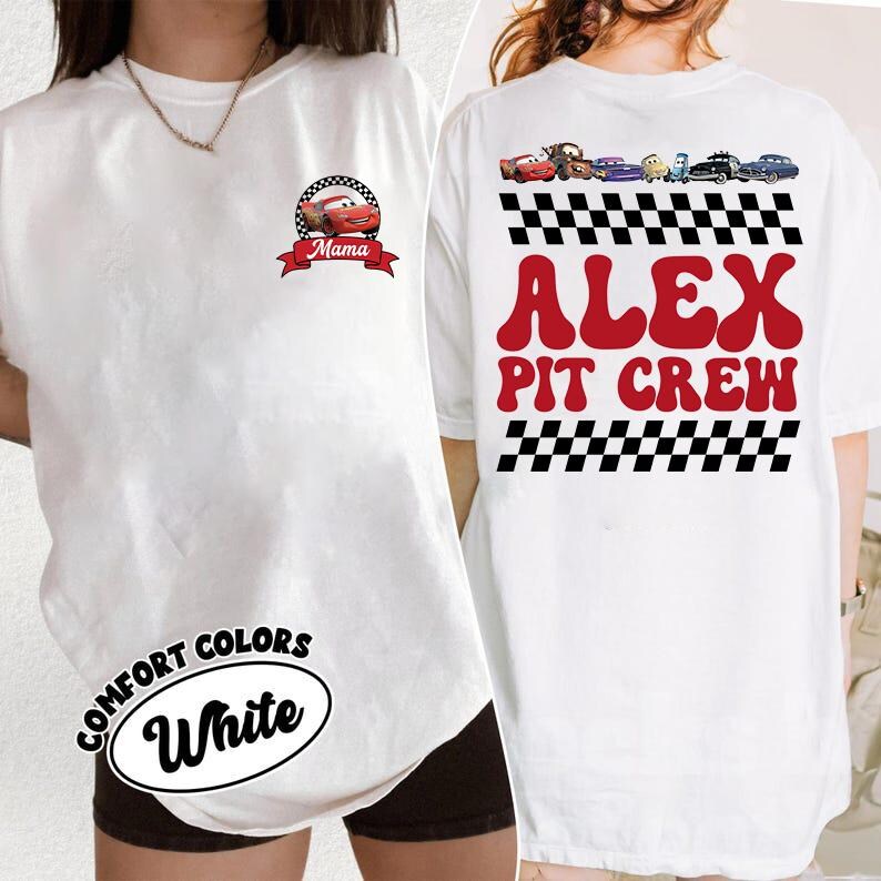 May include: A white t-shirt featuring a small graphic on the front left chest of a red race car inside a checkered circle with the text Mama. The back displays a row of race cars, checkered patterns, and the red text ALEX PIT CREW.