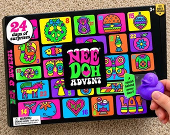 May include: A black Nee Doh Advent calendar box featuring 24 colorful numbered doors with various graphic illustrations including a burger, butterfly, and whale. The text reads 24 days of surprises, Nee Doh Advent, and a squish behind every door.