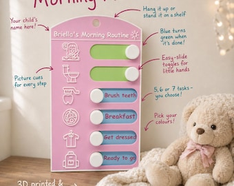 May include: A pink morning routine board with white sliding toggles and icons for daily tasks. The board features the text Briella's Morning Routine and includes labels like Brush teeth, Breakfast, Get dressed, and Ready to go. It has a hole for hanging and a flat base for standing.
