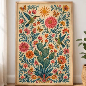 May include: A framed vertical wall art print featuring a central green prickly pear cactus surrounded by symmetrical floral patterns, two hummingbirds, three butterflies, and a sun icon in a warm color palette of pink, orange, and blue.