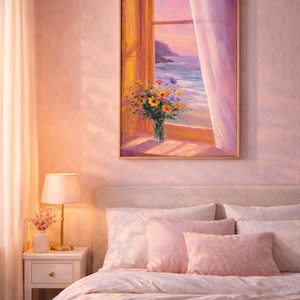 May include: A bedroom scene featuring a framed painting of a coastal view with flowers in a vase. The room has a bed with pink pillows and a bedside table with a lamp. The color scheme is soft pink and beige.