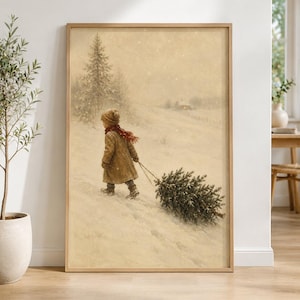 May include: A framed wall art print depicting a child in a tan coat and red scarf walking through a snowy landscape, pulling a small evergreen tree behind them. The scene features a soft, muted color palette with falling snow and distant trees.