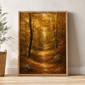 May include: A framed vertical wall art print depicting a forest path during autumn. The scene features tall trees with golden and orange foliage, a dirt trail covered in fallen leaves, and two large grey rocks resting on the forest floor.