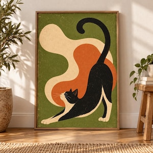 May include: A framed wall art print featuring a black and white cat stretching its body against a dark green background. Behind the cat are abstract, flowing shapes in cream and burnt orange colors. The cat has white paws and a white chest.