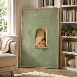 May include: A rectangular framed wall art piece featuring a textured sage green background. In the center, an arched window cutout reveals a painted scene of a figure in a white dress sitting in a stone alcove, reading an open book.