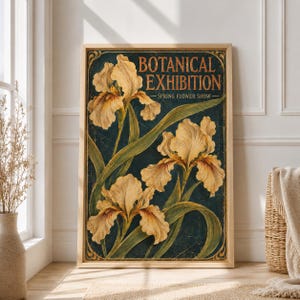 May include: A rectangular wall art print featuring three pale yellow iris flowers with green stems and leaves against a dark navy blue background. The text BOTANICAL EXHIBITION SPRING FLOWER SHOW is printed in a gold serif font at the top.