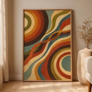 May include: A rectangular wall art print in a light wood frame featuring an abstract design of concentric circles and flowing, wavy lines in shades of burnt orange, mustard yellow, olive green, deep brown, and muted teal on a cream background.