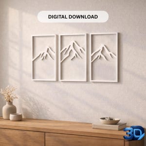 Può includere: Tre opere d'arte di montagne incorniciate in bianco appese a una parete. L'opera presenta un design minimalista di catene montuose. Il testo "DIGITAL DOWNLOAD" è visualizzato sopra. L'arte è sopra un mobile in legno.