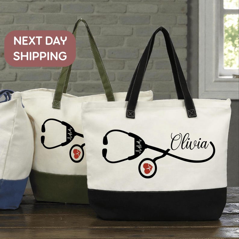 two tote bags with medical-themed designs, including stethoscopes and a heart symbol. The bags are placed on a wooden surface, and there is a brick wall in the background.