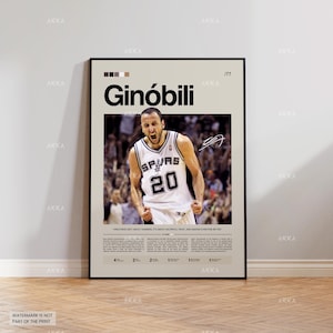 May include: A framed poster featuring a basketball player in a white and black jersey with the number 20. The poster has the name "Ginóbili" in large black letters and includes a signature. The background is a beige color.