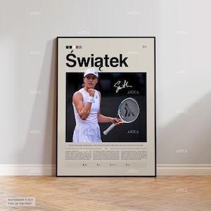 May include: A framed poster featuring the name "Świątek" in large black letters. The poster includes a photo of a tennis player in white attire holding a racket. The poster has a beige background with text and a signature.