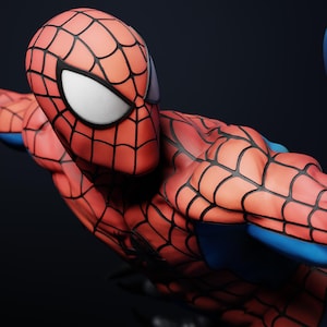 May include: A detailed figurine of Spider-Man in a dynamic pose. The figure features a red and black webbed suit with blue accents. The eyes are white, and the overall design is highly detailed.