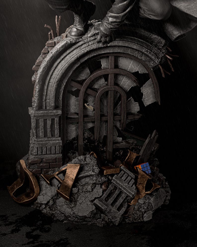 May include: A detailed statue depicting a crumbling architectural structure with a broken arched window. The statue features a figure in a dark coat and boots, perched atop the structure. The color palette is primarily gray, brown, and bronze, with a Rubik's Cube visible.