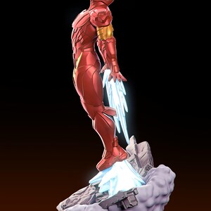 May include: A red and gold Iron Man figurine in a dynamic pose, with blue energy effects emanating from the feet and hands. The figure is standing on a rocky base with a black pedestal, set against a dark background.