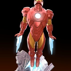 May include: A red and gold Iron Man figure in a dynamic pose, with blue energy effects emanating from the hands and feet. The figure is standing on a rocky base with a glowing arc reactor in the chest. The background is black.