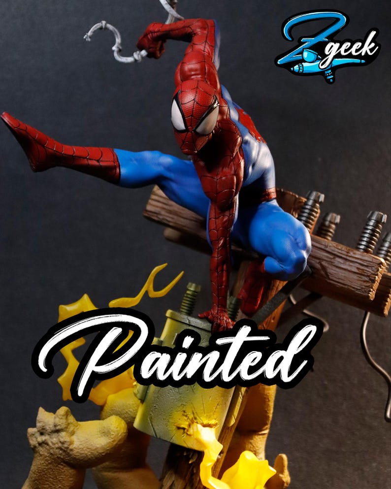 May include: A painted Spider-Man figurine in a dynamic pose, wearing a red and blue suit. The figure is perched on a wooden structure with electrical components. The image includes the text "Painted" and the "Z geek" logo.