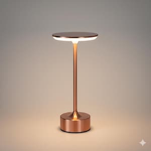 May include: A copper-colored table lamp with a round top and base. The lamp has a slender stem and a bright, circular light source. The lamp's dimensions are approximately 12 inches in height and 6 inches in diameter.