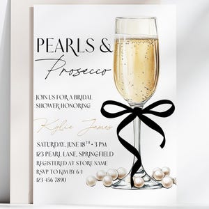 May include: Bridal shower invitation with the text "Pearls & Prosecco". The invitation features a champagne flute with a black bow and pearls. The invitation includes the name Kylie James, date, time, and location.