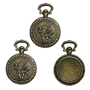 May include: Antique bronze-colored pocket watch pendants. Two pendants feature a rabbit character with a walking stick and heart-shaped details. The third pendant has a blank face. Each pendant has a decorative loop at the top.