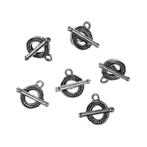 May include: Six silver-toned toggle clasps. Each clasp features a circular ring with a decorative rope-like border, a bar, and a small loop. The clasps are scattered against a white background.