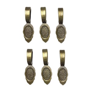 May include: Six antique brass-colored pendant bails. Each bail has a loop at the top and an oval-shaped base with a textured, dotted pattern. The bails are arranged in two rows of three against a white background.
