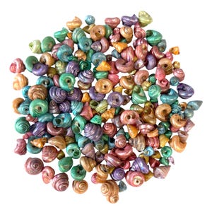 May include: A white ceramic mug with a black handle and the text "But First, Coffee" in a black, bold font. The mug is sitting on a white surface. The mug is approximately 4 inches tall.