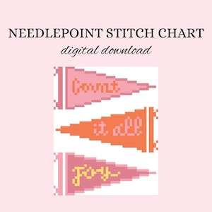 May include: Needlepoint stitch chart digital download. The image features three colorful pennant flags with the words "Count", "it all", and "Joy". The flags are in shades of pink and orange, with white accents. The background is a soft pink.