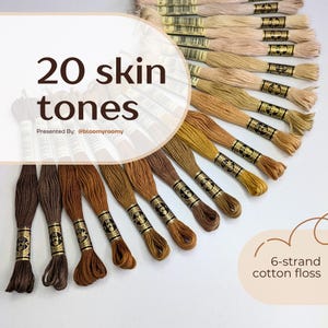 Puede incluir: Colección de hilo de algodón de 6 hebras en 20 tonos de piel. Los hilos están dispuestos en forma de abanico, con tonos que van desde el beige claro hasta el marrón oscuro. El texto "20 skin tones" se muestra. También "6-strand cotton floss".