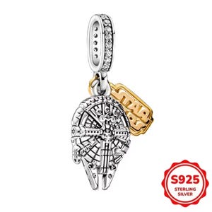 May include: A sterling silver charm depicting the Millennium Falcon, with a gold-coloured Star Wars logo tag. The charm has a silver bail with clear stones. The charm is marked S925 Sterling Silver.