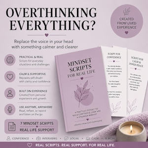 May include: A book titled "Mindset Scripts for Real Life" with accompanying scripts and a lit candle. The book is lavender with a floral design. Text on the book cover reads "A practical toolkit to build confidence, calm and a stronger mindset."