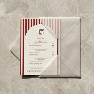 May include: A price menu from "bare skin studio" with a white and red striped design. The menu lists facials, advanced treatments, and targeted care options. The menu is inside a translucent envelope.