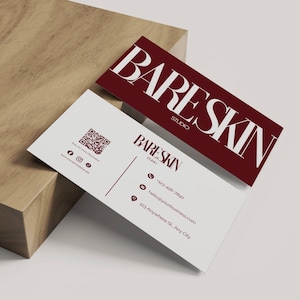 May include: Two business cards with the text "BARESKIN STUDIO" in a modern font. One card is burgundy with white text, the other is white with burgundy text and contact information. A QR code is also visible.